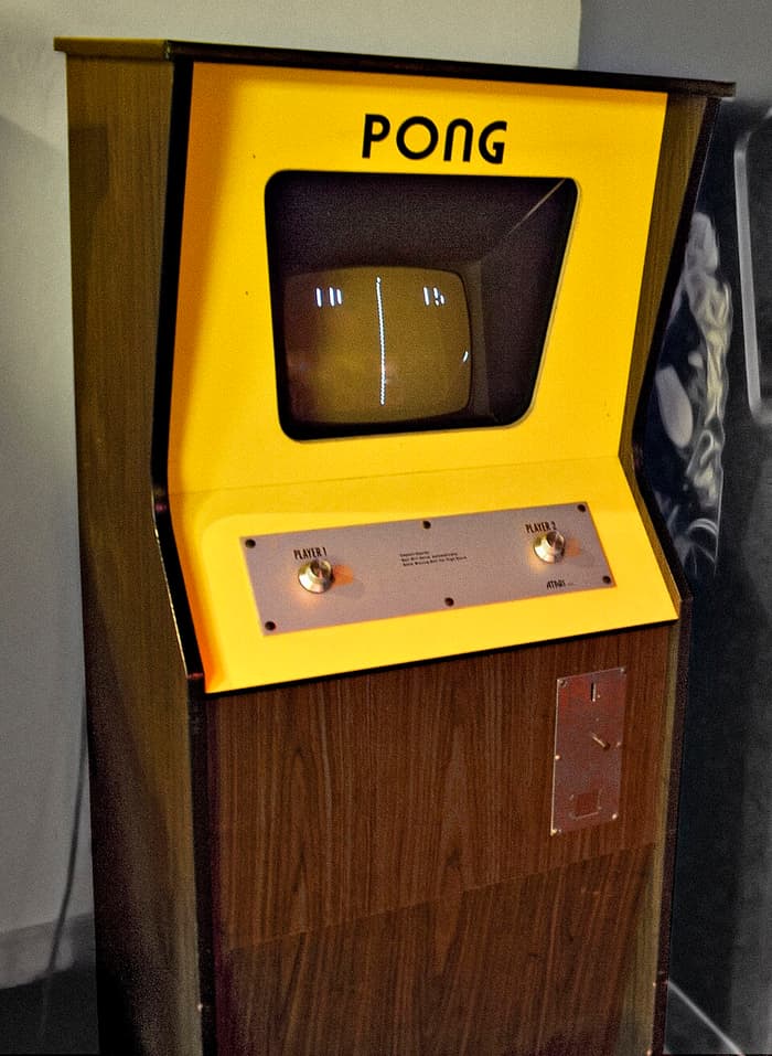 Yellow and wood-grain Pong arcade cabinet