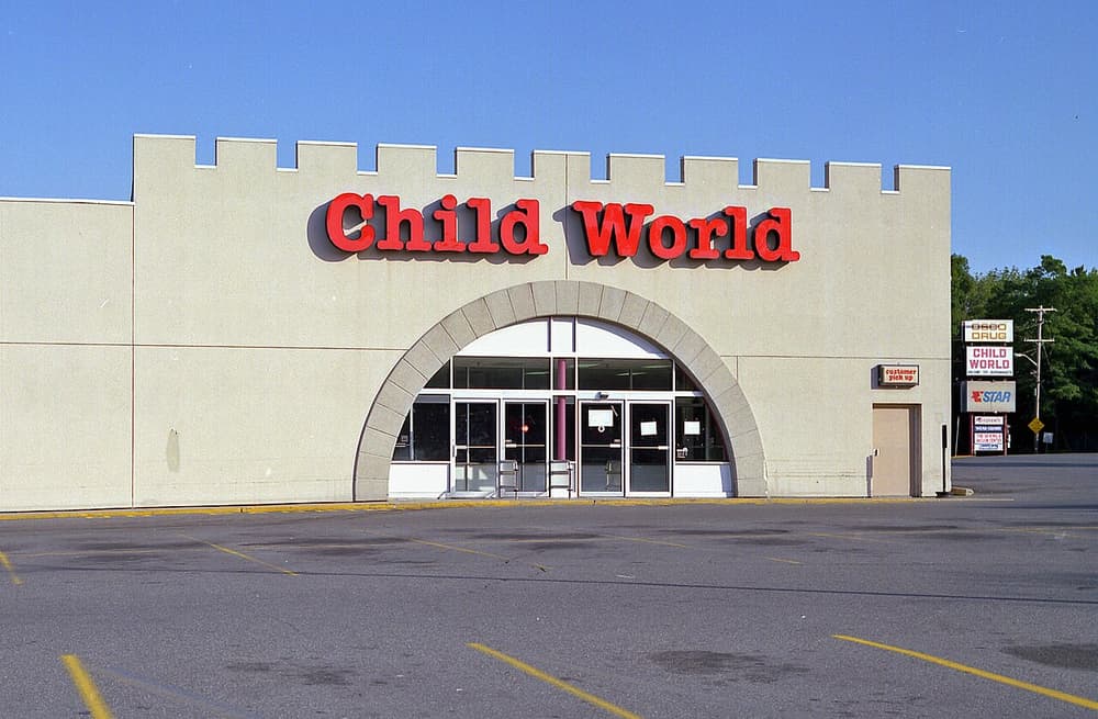 An empty Child World store with red letters over an arched entrance