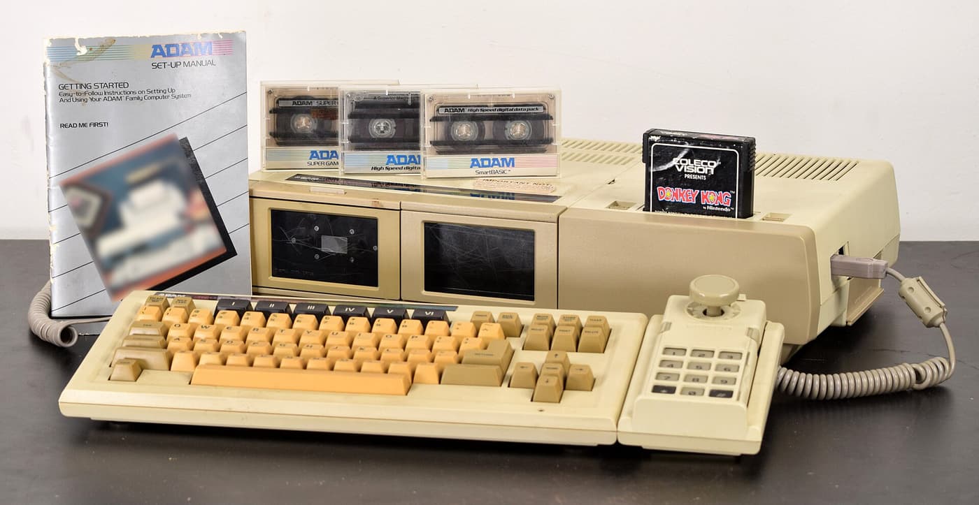 A beige Coleco Adam computer with keyboard, printer and tape drives